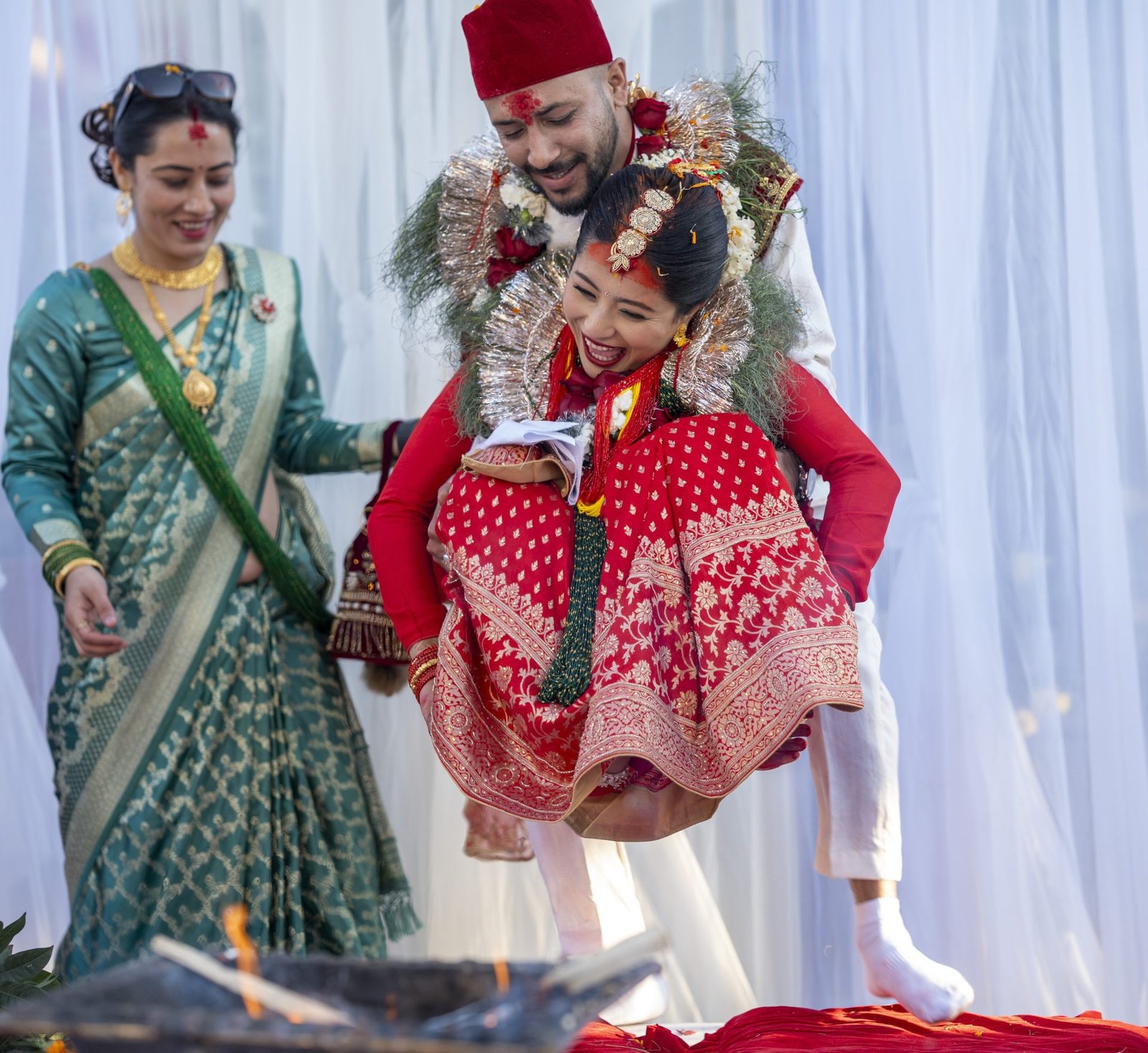 Groom carrying laughing bride during the wedding ceremony